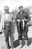 Fritz and Fred Roethlisberger comparing fish sizes.